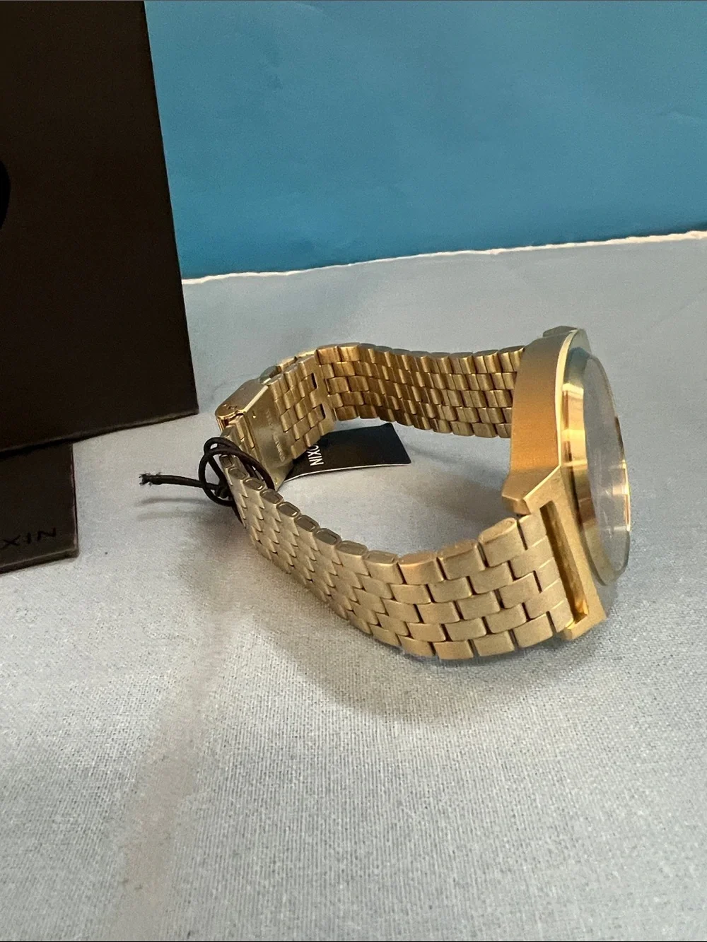 Nixon Gold Watch with Black Dial and Red Accents, Time Teller Model